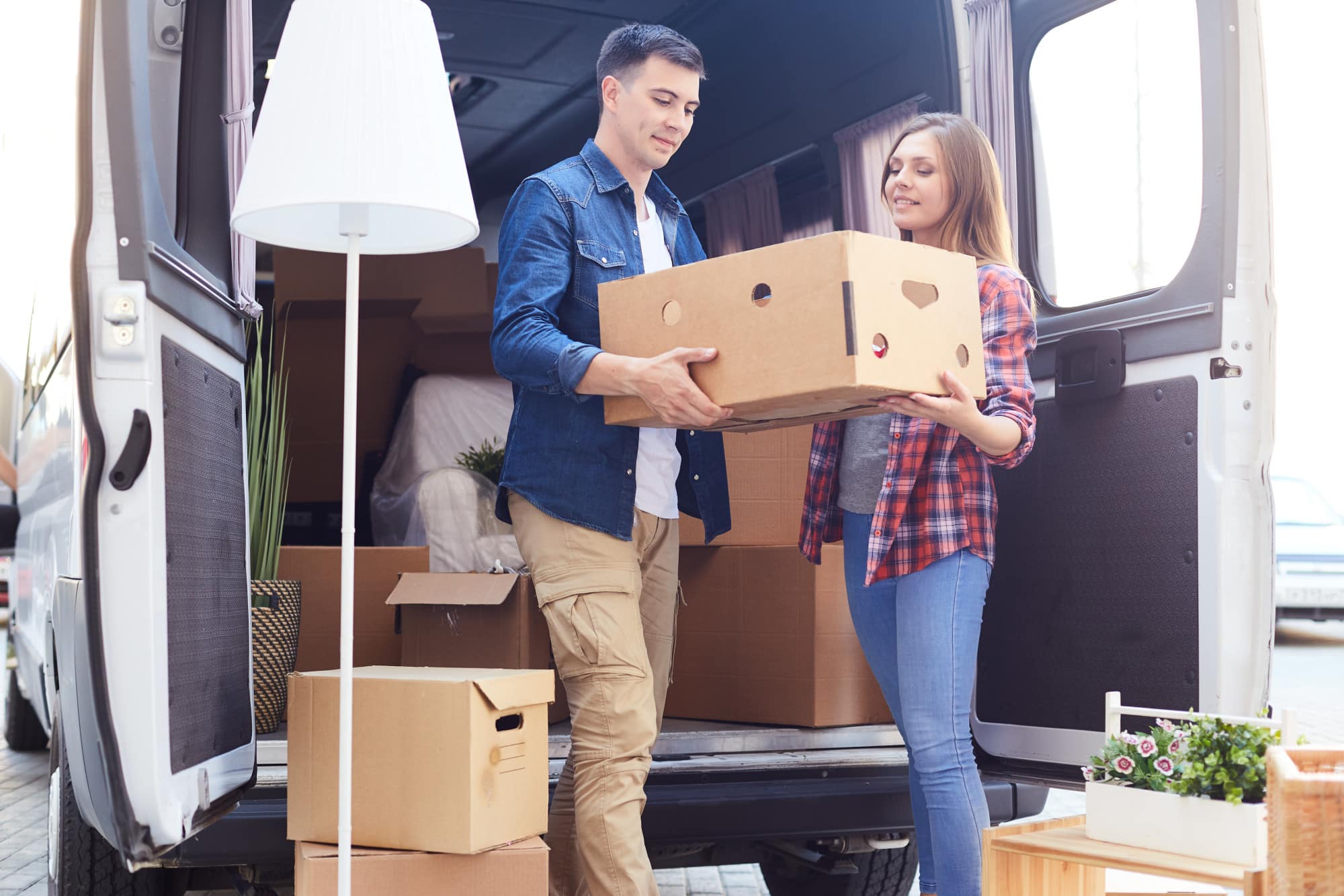 Young Couple Unloading Moving Van
